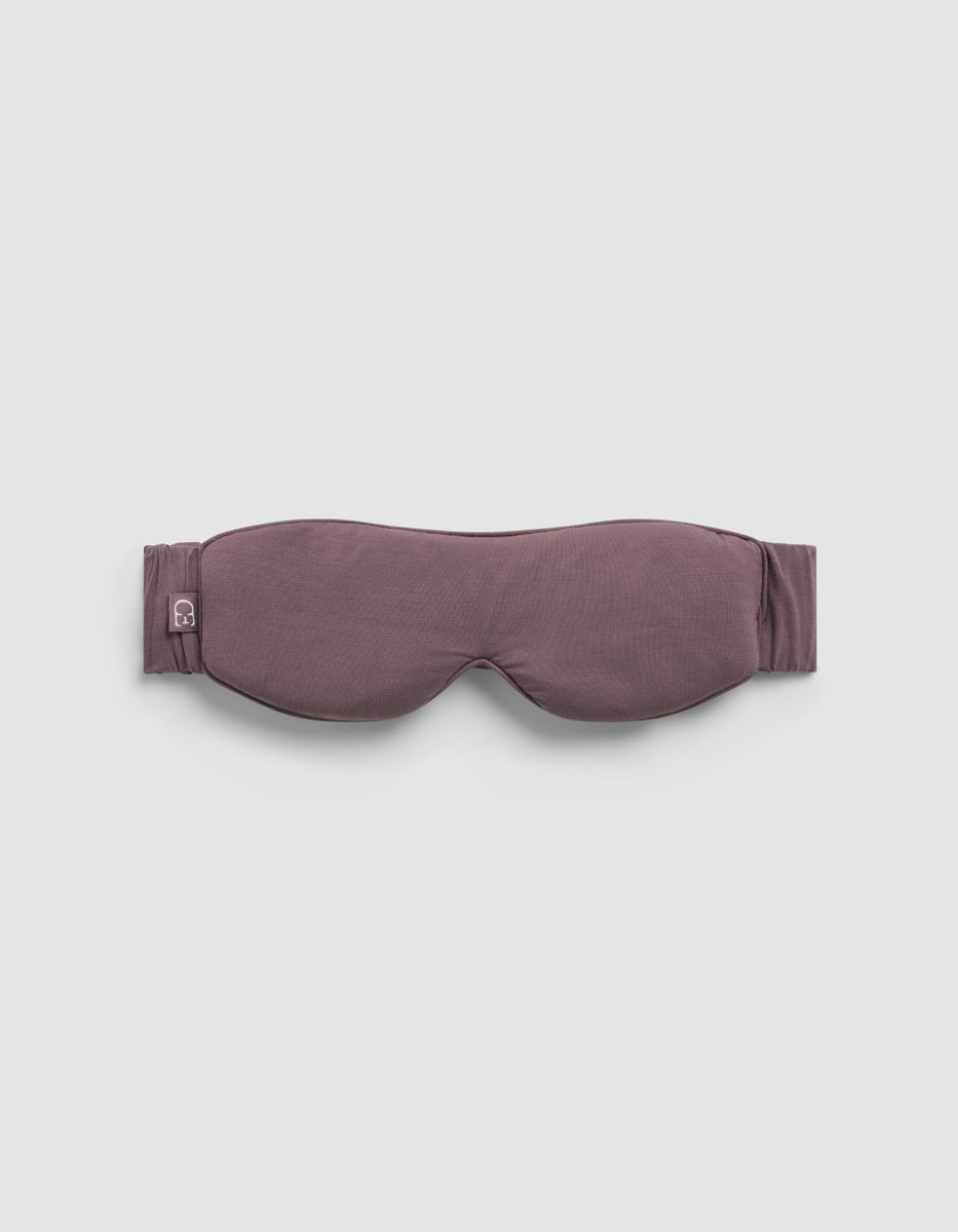 Mauve Cozy Earth Bamboo Stretch-Knit Sleep Mask with a stretchy head strap and a small logo tag on the side.