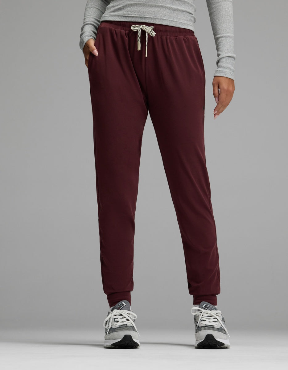 A person wearing Cozy Earth’s Women’s Studio Jogger stands against a plain gray background with hands in pockets.