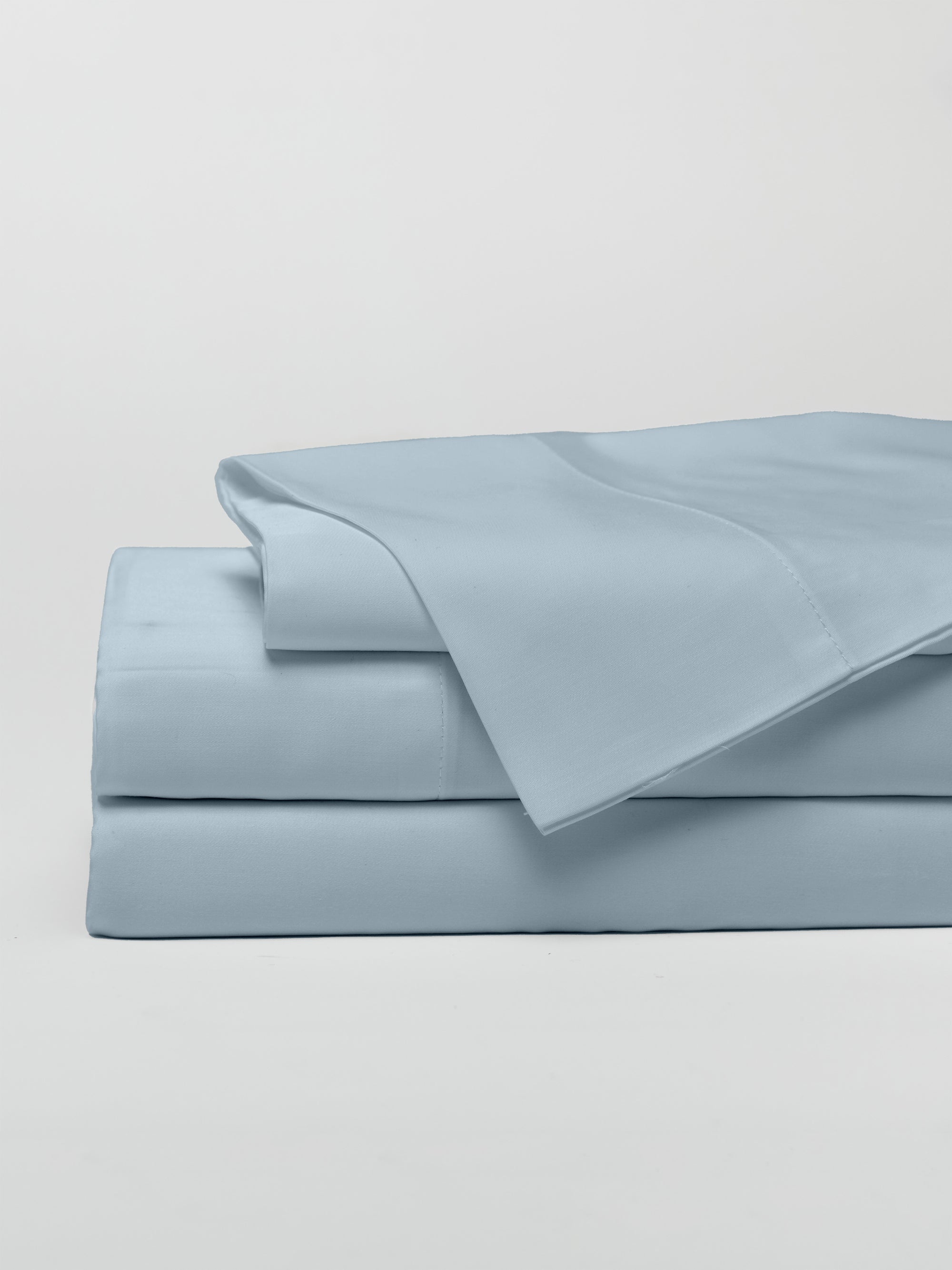 Harbor Mist sheet set folded with a white background 