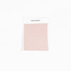 A sample swatch of Bamboo Sheet fabric from Cozy Earth, in light pink, is displayed on a white card against a white background.|Color:Peony