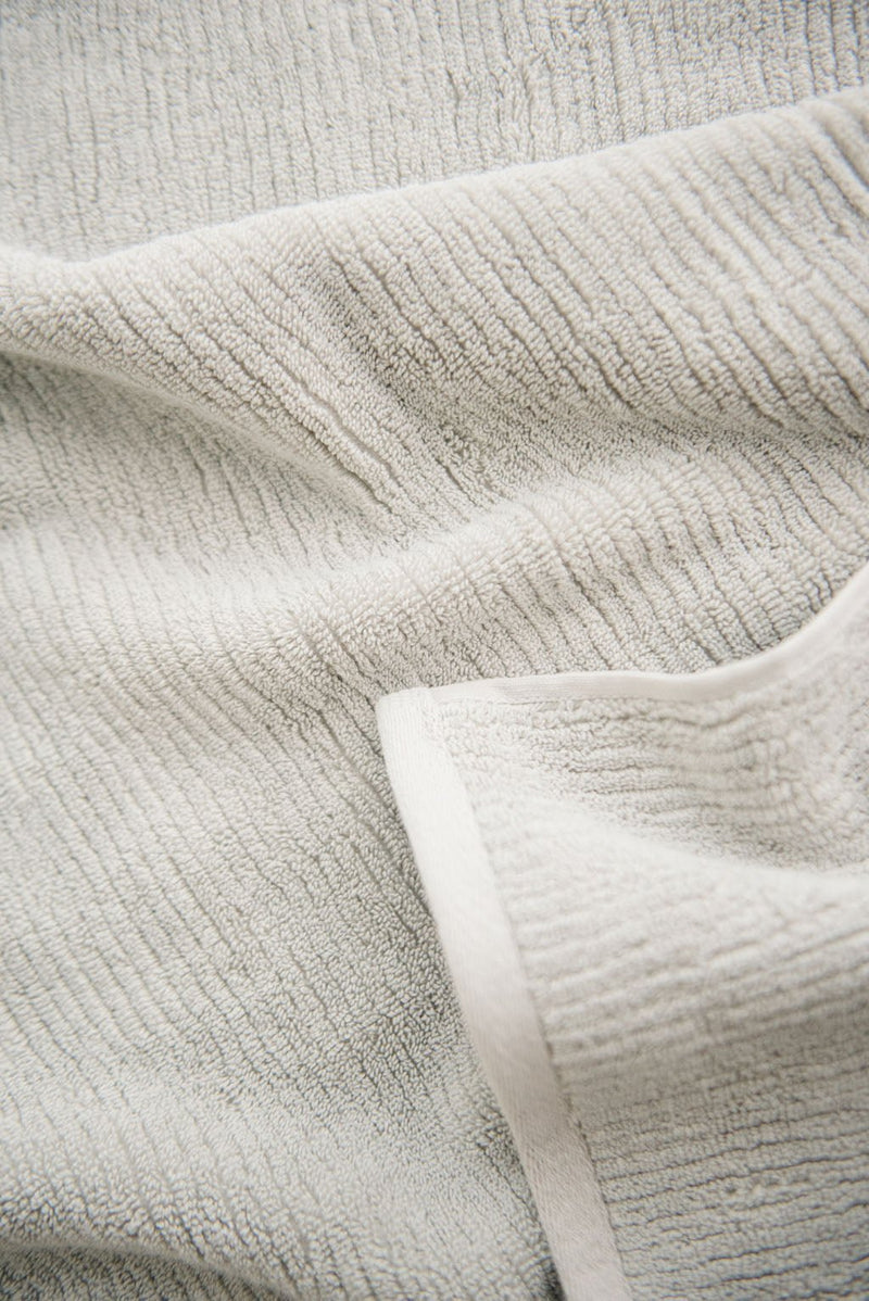 Ribbed Terry Hand Towel in the color Light Grey. Photo of Ribbed Terry Hand Towel taken as a close up of the towel. Only the towel is seen.