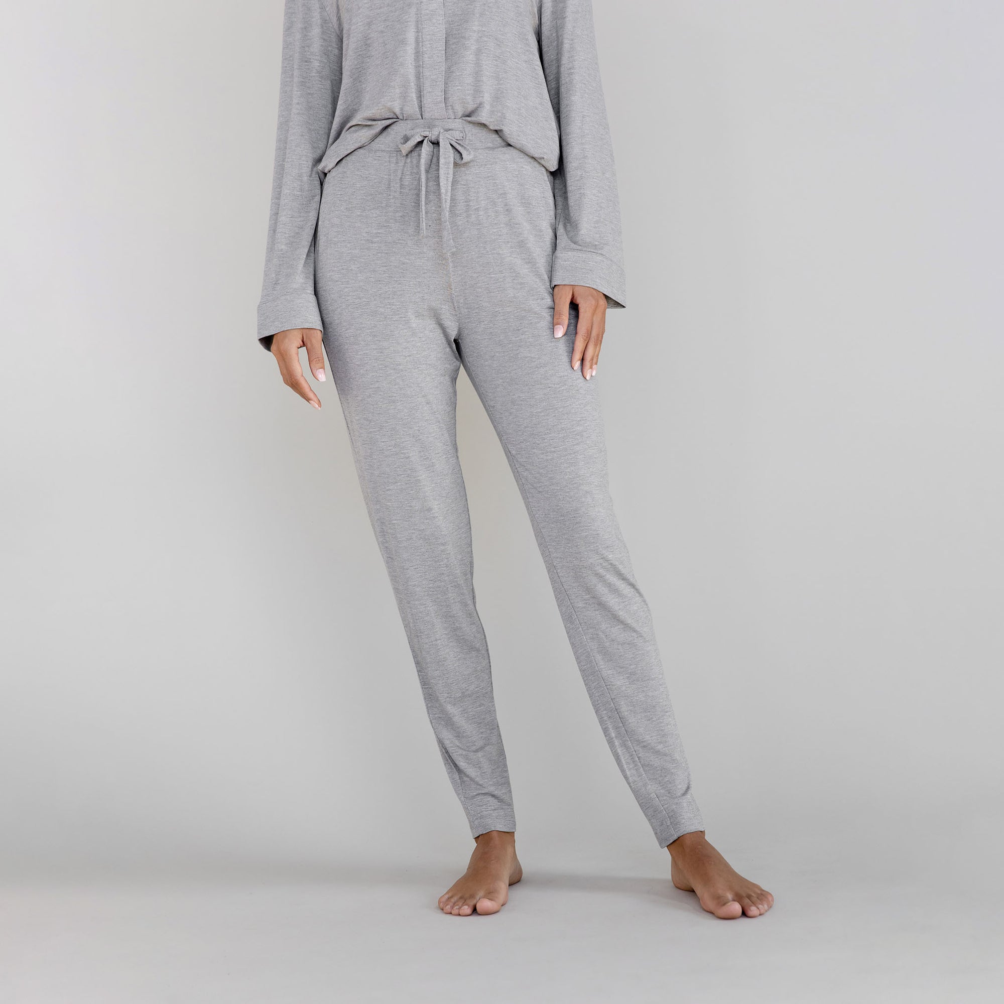 Gray pajama set worn by a person on a light gray background 
