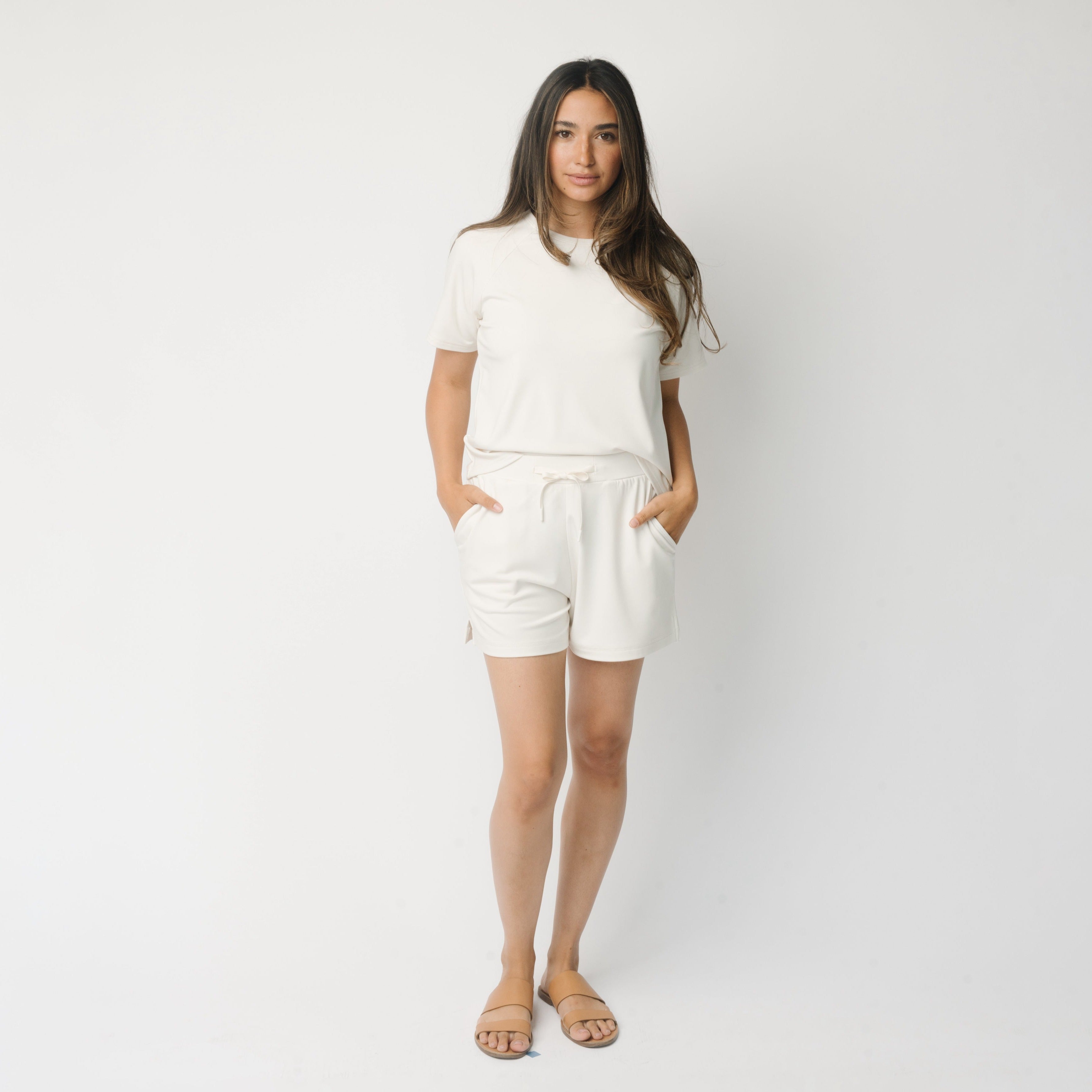 Woman wearing a white t-shirt and white Cozy Earth Brushed Bamboo Shorts shorts on a plain background |Color:Ivory