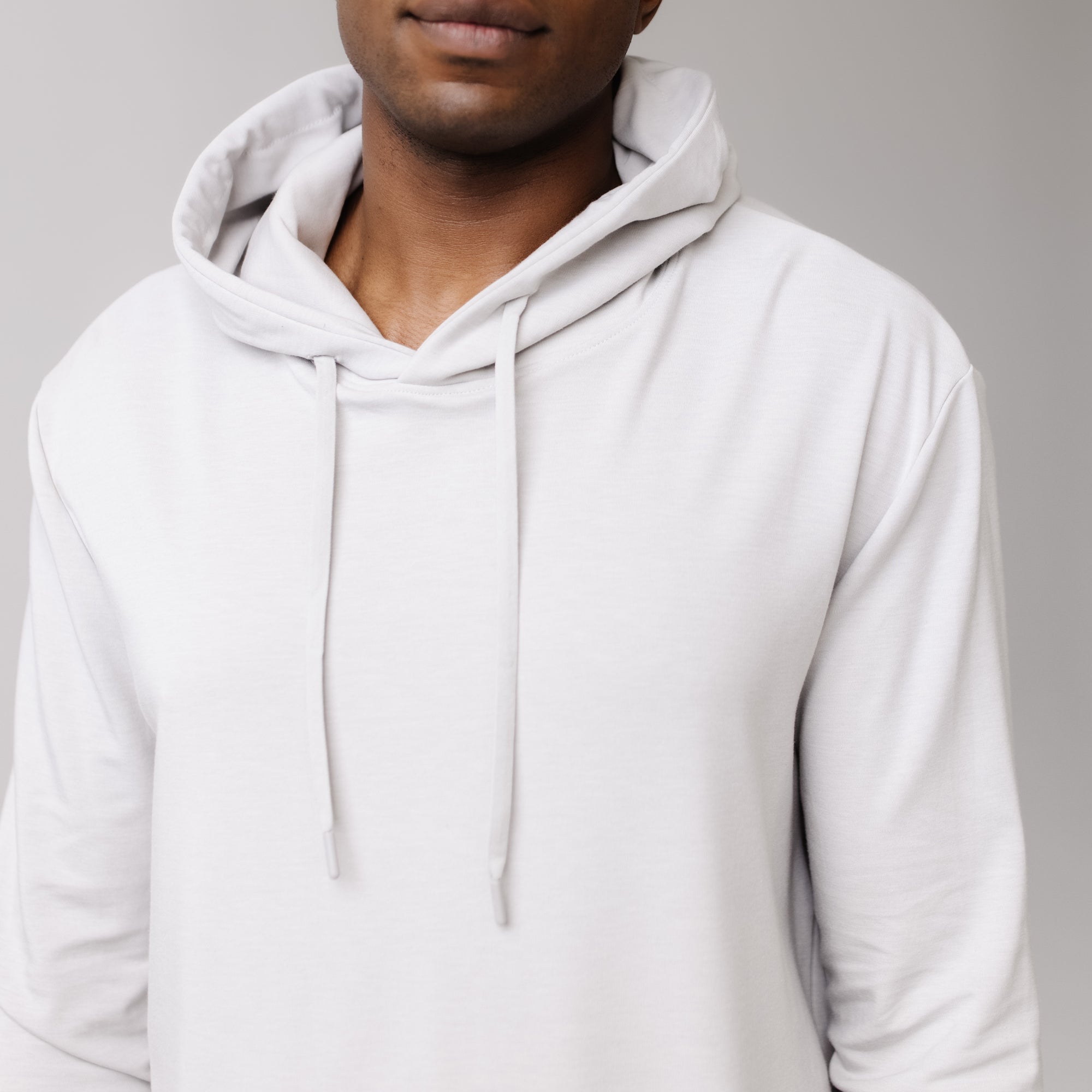 Light Grey Bamboo Hoodie worn by a man standing in front of white background.